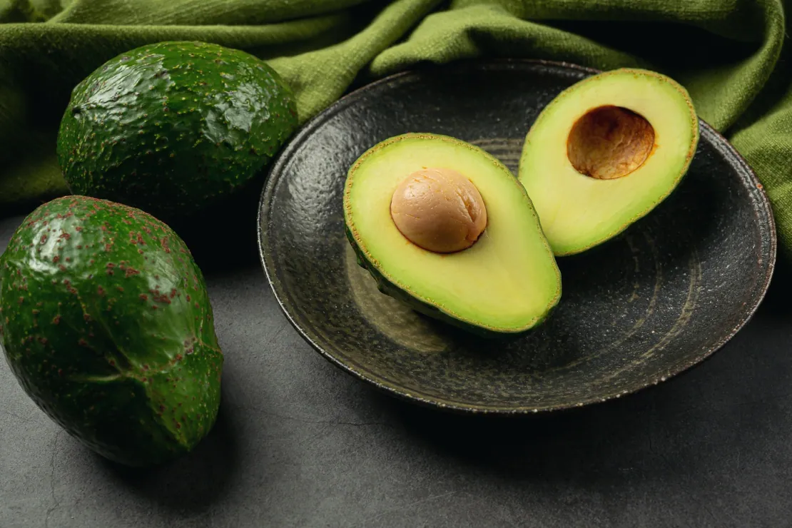 Sliced avocado on a plate, symbolizing healthy fats and nutrition.