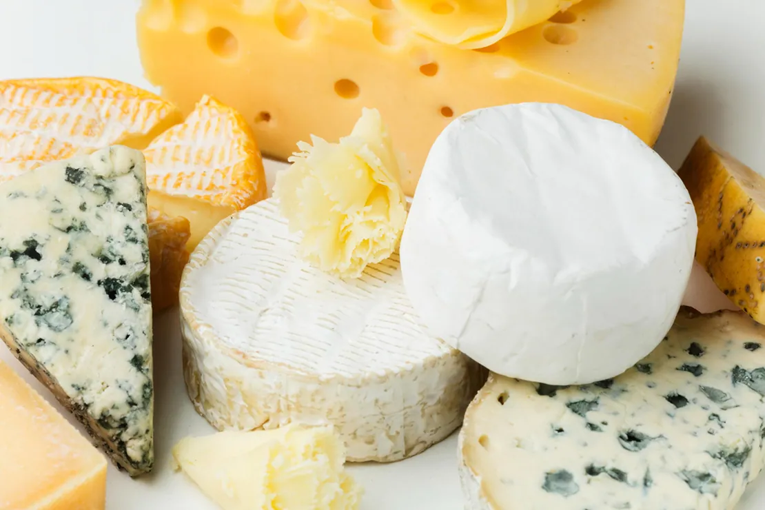 A vibrant display of cheddar, feta, and mozzarella cheeses, symbolizing diverse options for a calorie-conscious diet.